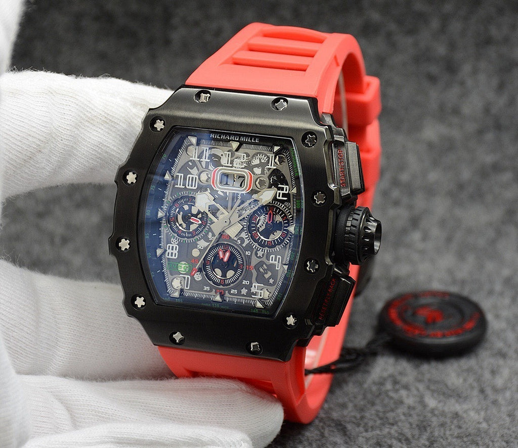 Richard Mille watch with black case, dark dial, and bright red rubber strap