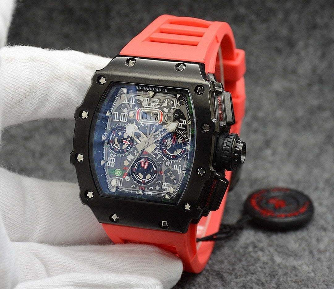 Richard Mille watch with black case, dark dial, and bright red rubber strap