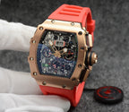 Richard Mille watch with rose gold case, dark dial, and bright red rubber strap