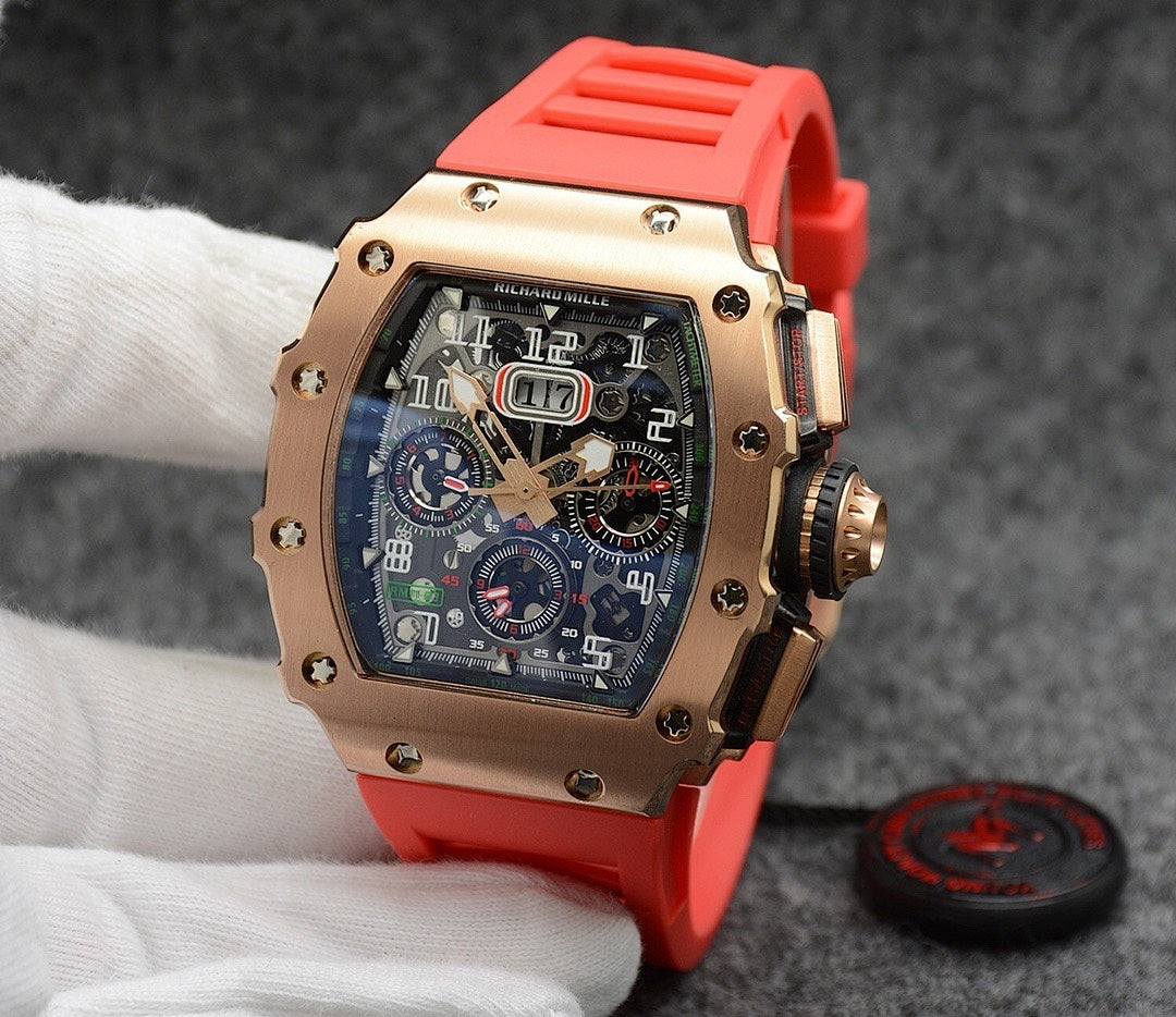 Richard Mille watch with rose gold case, dark dial, and bright red rubber strap