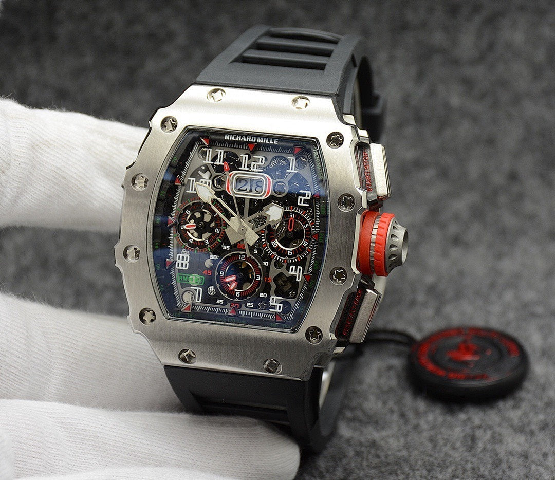 Richard Mille watch with silver case, black dial, and black rubber strap
