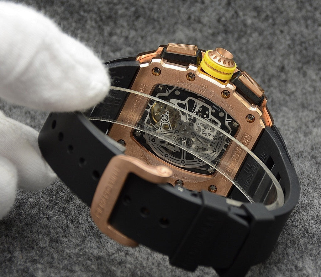 Richard Mille watch case back with black strap, exposed movement and copper accents