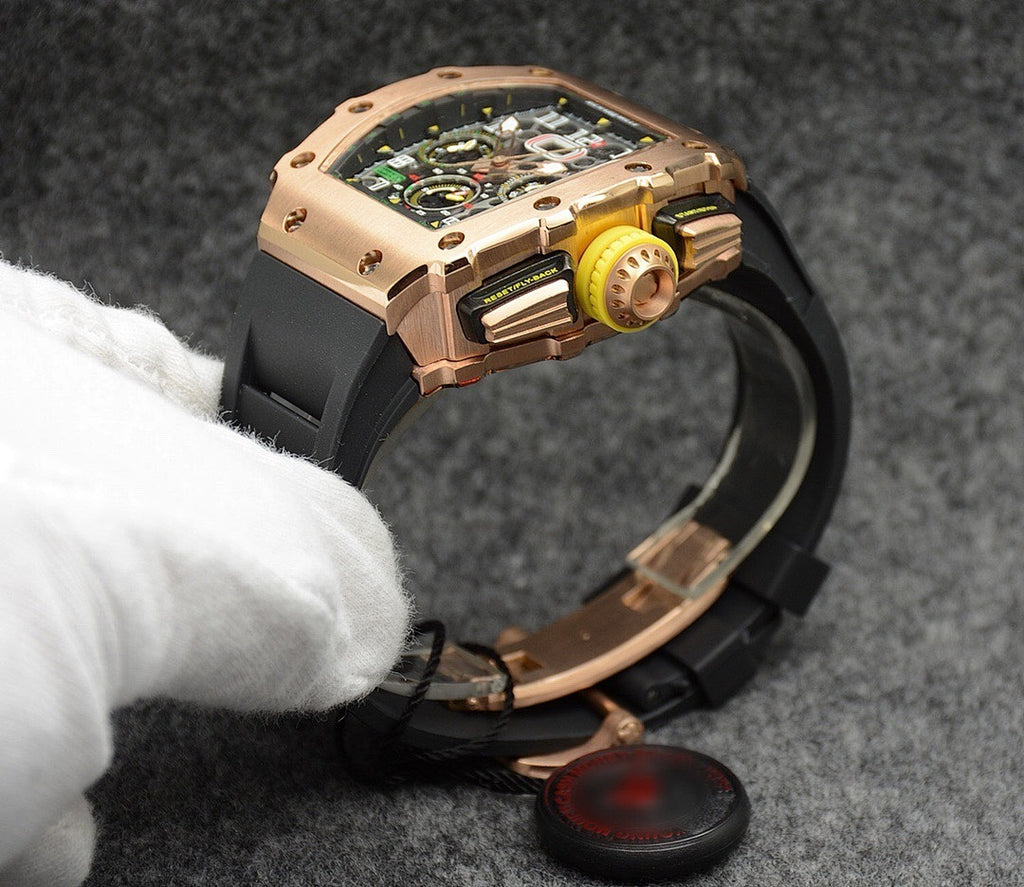 Richard Mille watch with rose-gold case, black strap, side view with exposed movement