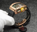 Richard Mille watch with rose-gold case, black strap, side view with exposed movement