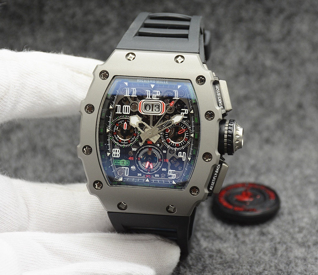 Richard Mille watch with silver case, blue dial, and black rubber strap