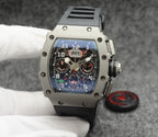 Richard Mille watch with silver case, blue dial, and black rubber strap