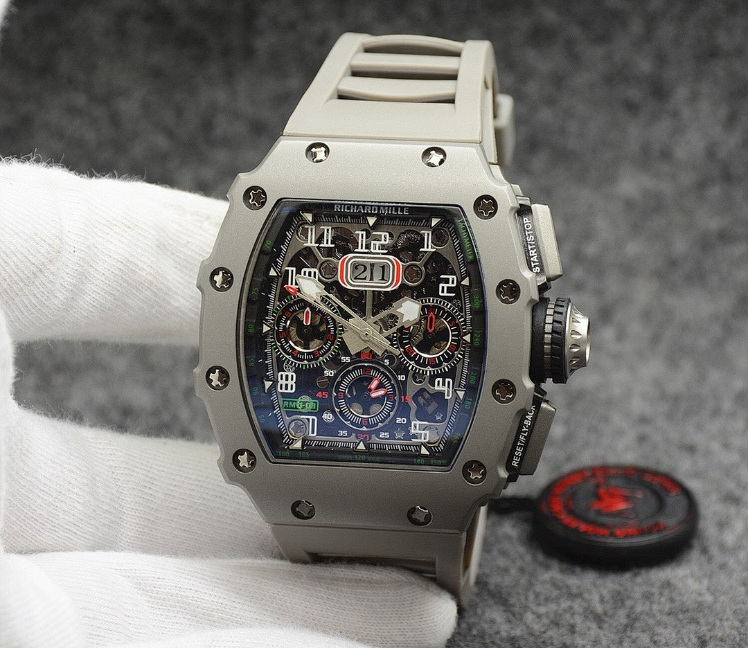 Richard Mille watch with silver case, black dial, and light gray rubber strap