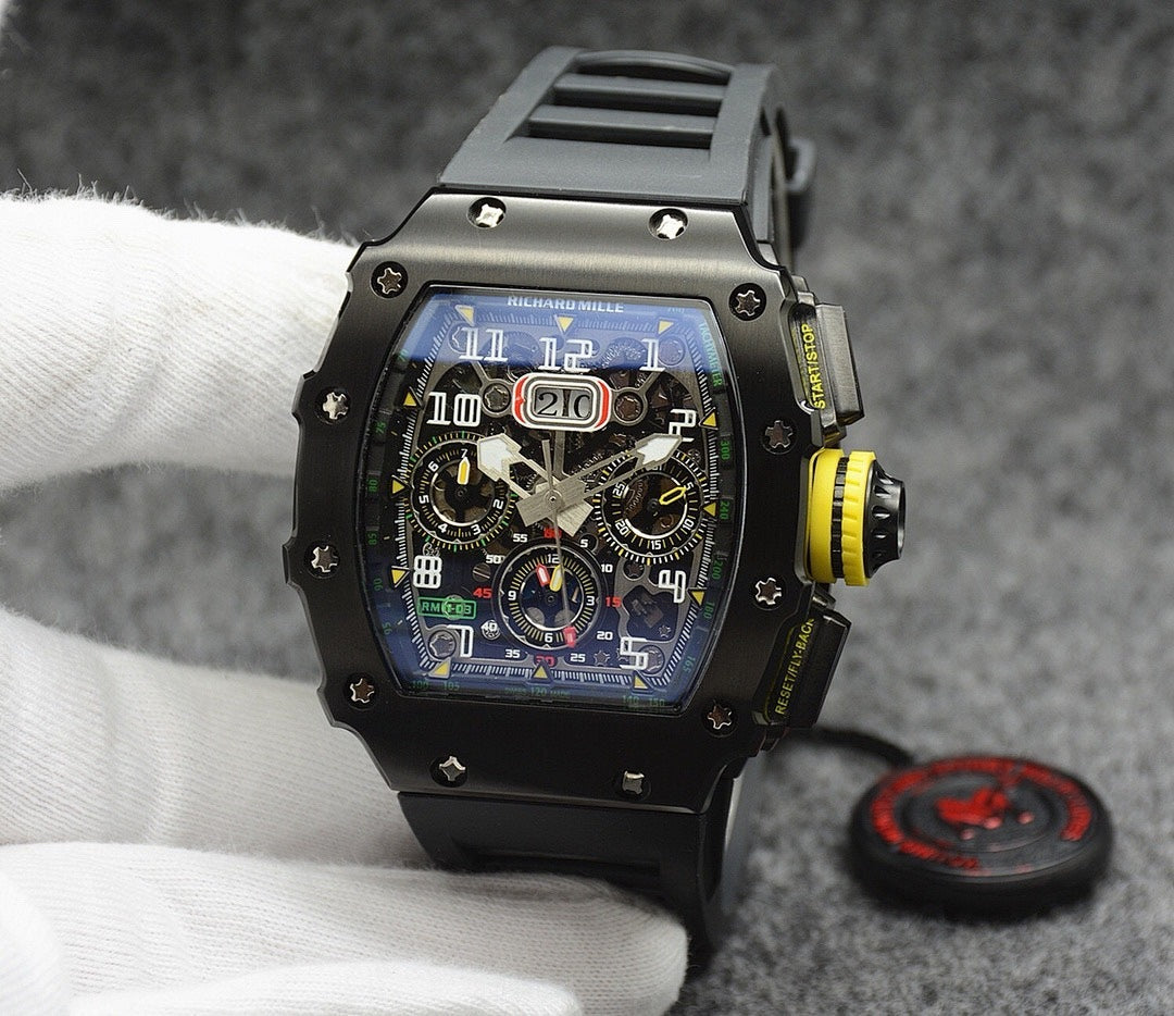 Richard Mille watch with black case, black strap, multi-dial skeleton face with yellow detail