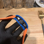 Richard Mille watch side view with blue and orange bezel, textured strap