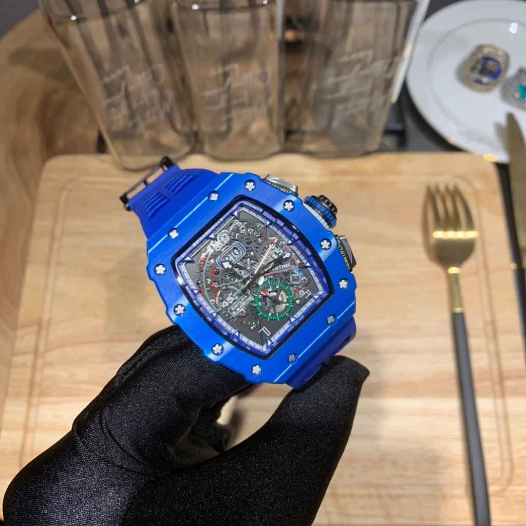 Richard Mille watch with blue case and black strap, blue-toned skeleton dial