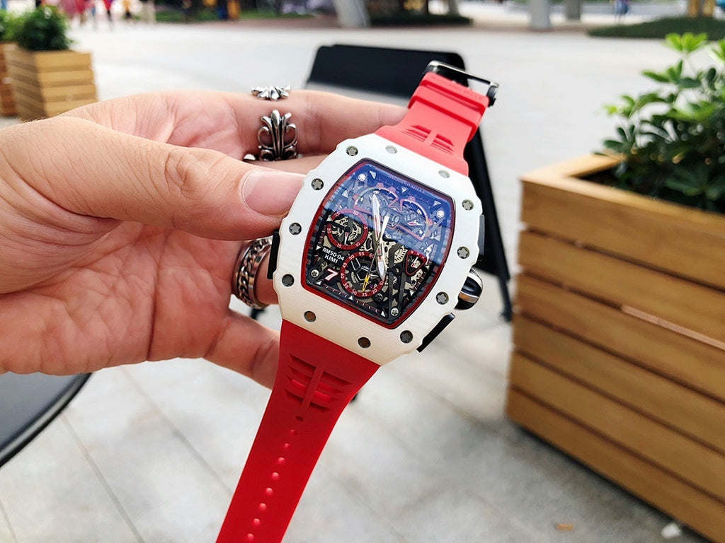 Richard Mille watch front with red rubber strap and white case, blue-toned skeleton dial