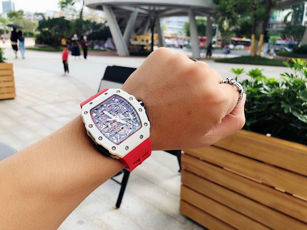 Richard Mille watch on wrist, white case with red rubber strap and skeleton dial