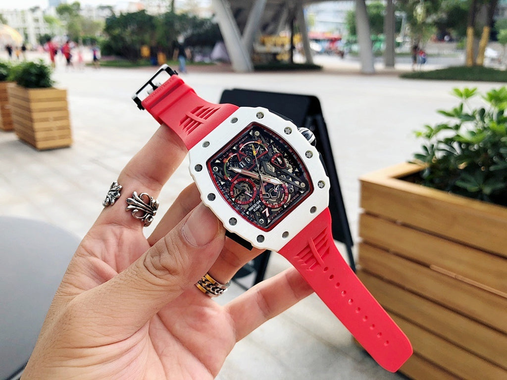 Richard Mille watch on wrist, red rubber strap with white case and skeleton dial