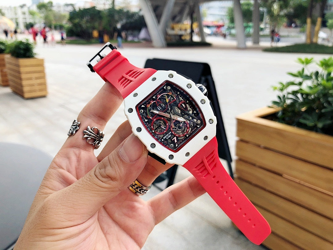 Richard Mille watch on wrist, red rubber strap with white case and skeleton dial