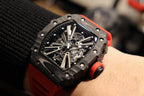 Richard Mille watch close-up with black octagonal case and intricate metal dial
