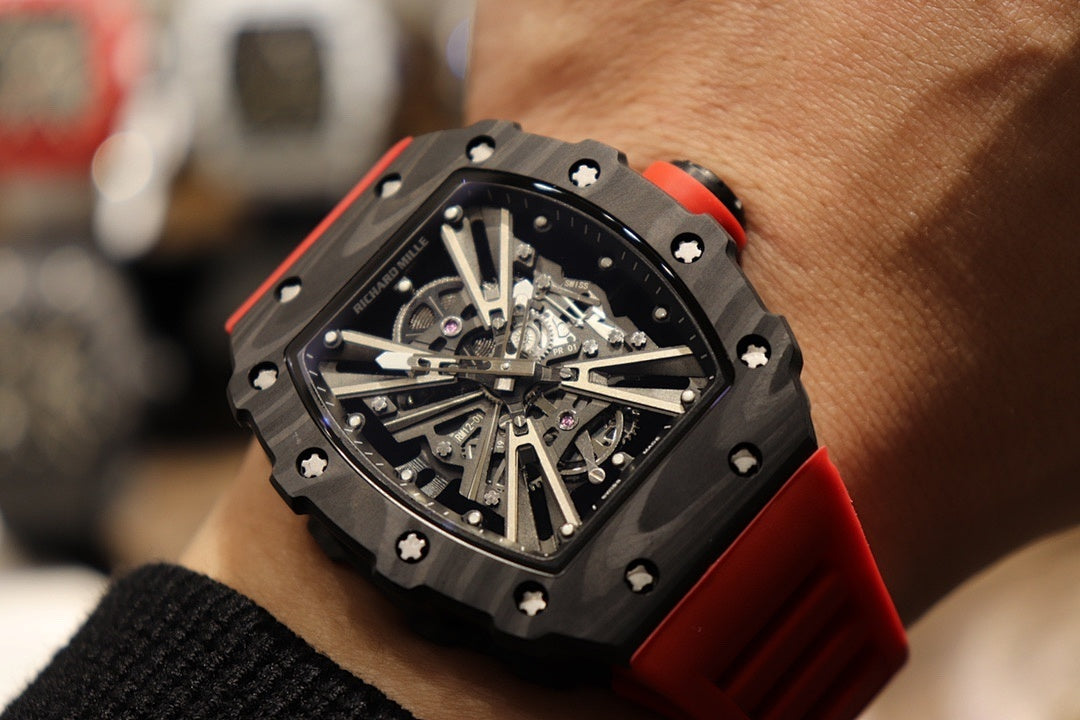 Richard Mille watch angled close-up with black case and red rubber strap