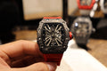 Richard Mille watch with black octagonal case and skeletal dial on red strap