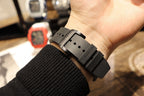 Richard Mille watch underside close-up, black strap with buckle and strap holes