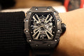 Richard Mille watch with black skeleton dial and metal accents, on black strap