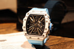 Skeleton sports watch with light blue silicone strap, white case, black dial