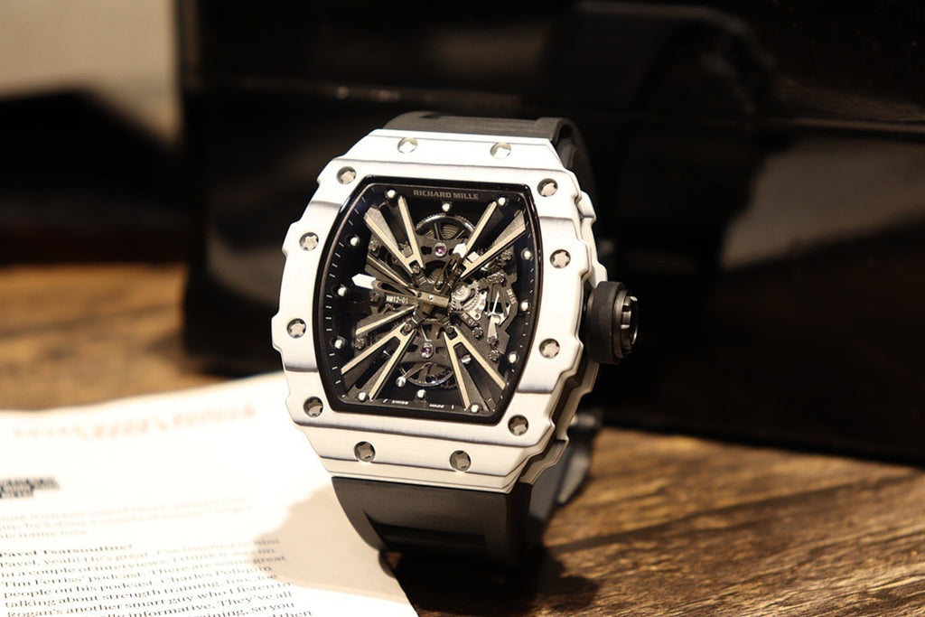 Skeleton sports watch with white silicone strap, white case, black dial and metal details