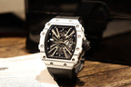 Skeleton sports watch with white silicone strap, white case, black dial and metal details