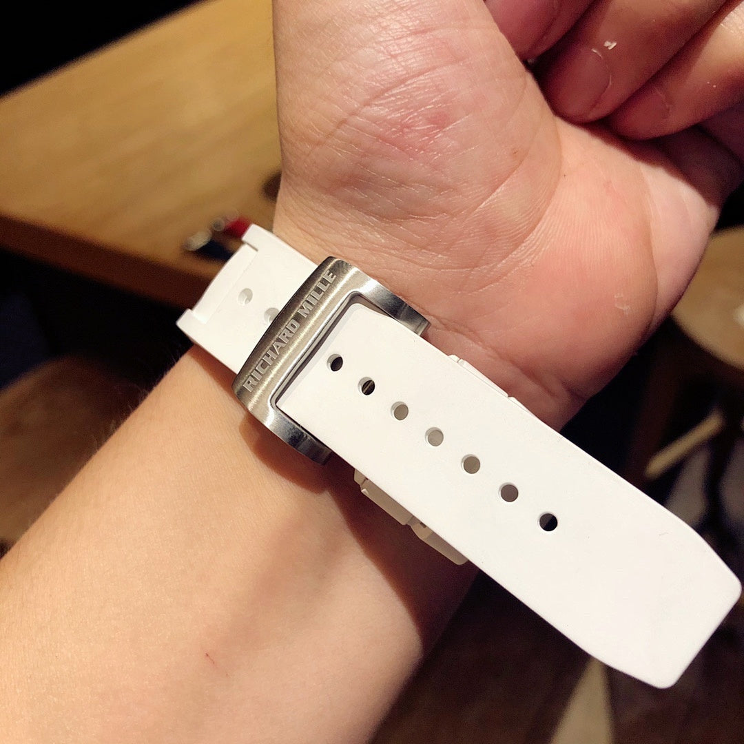 White rubber watch strap with buckle holes and metal clasp