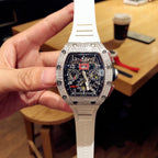 Square luxury watch with dark blue dial, jeweled bezel, and white rubber strap