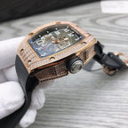 Richard Mille watch side view, rose-gold diamond bezel, black strap, visible crown