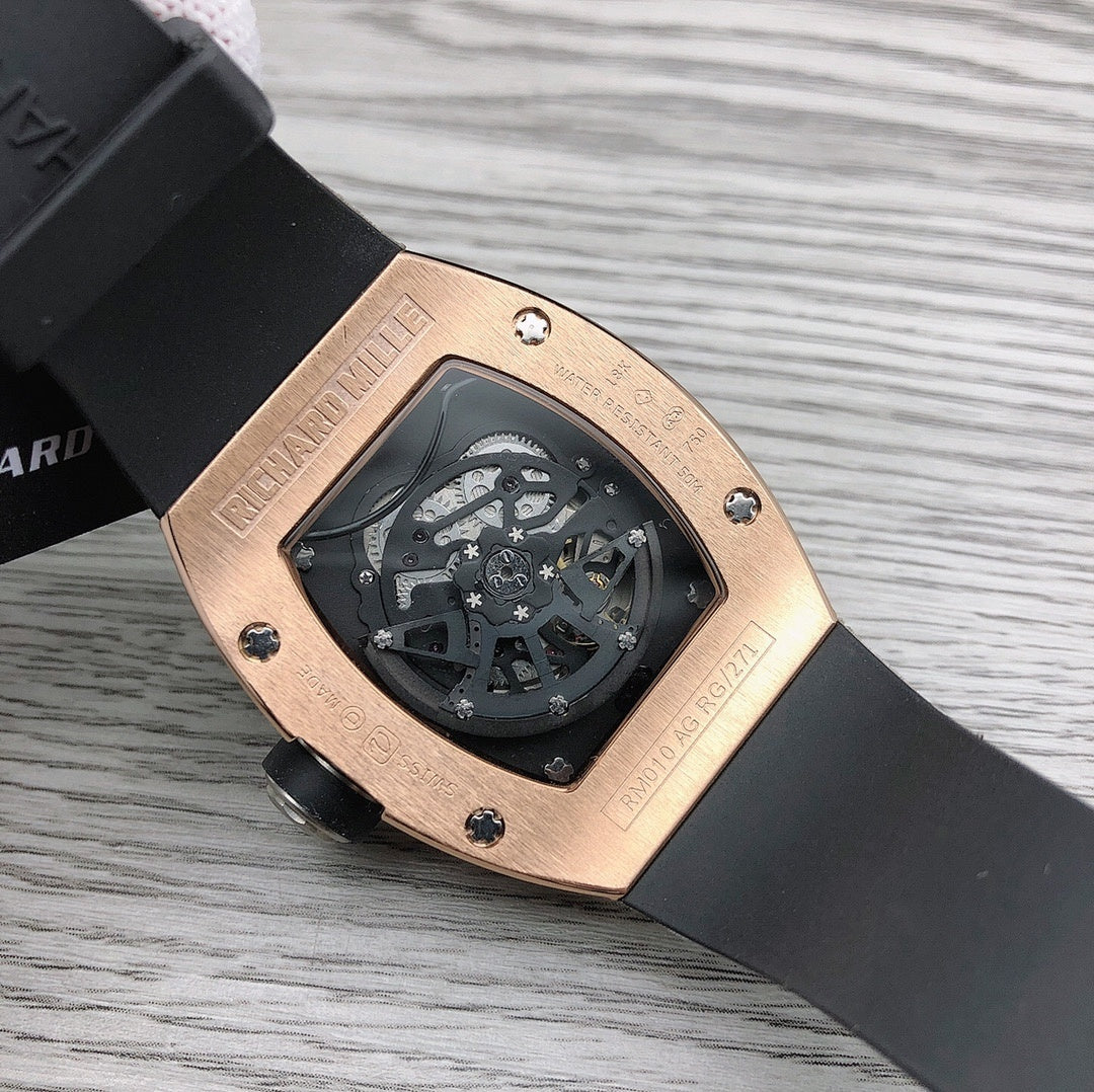 Richard Mille watch back view, rose-gold case, black rubber strap with screw details