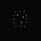 Watch dial with green glowing markers on a dark background