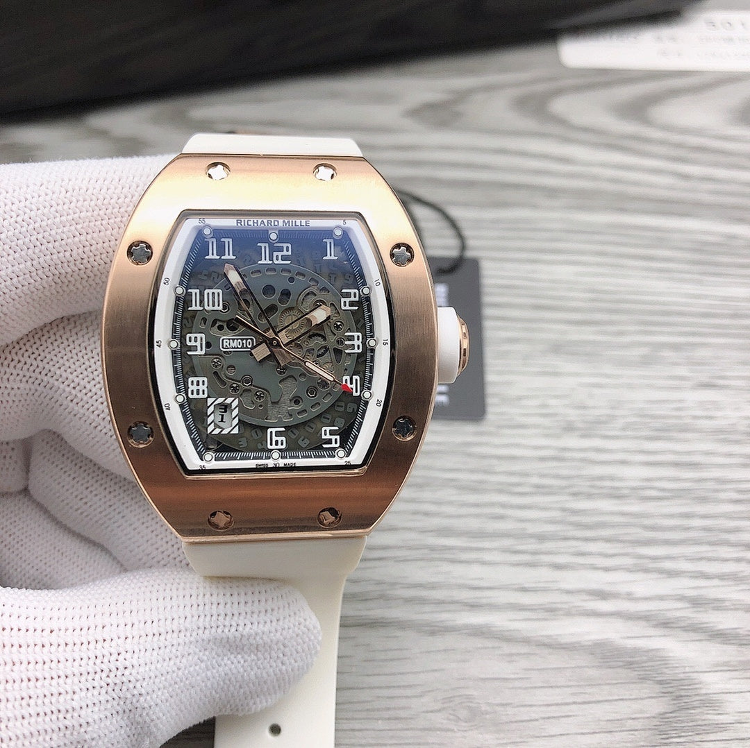 Richard Mille watch with gold-toned case, skeleton dial, and light strap.