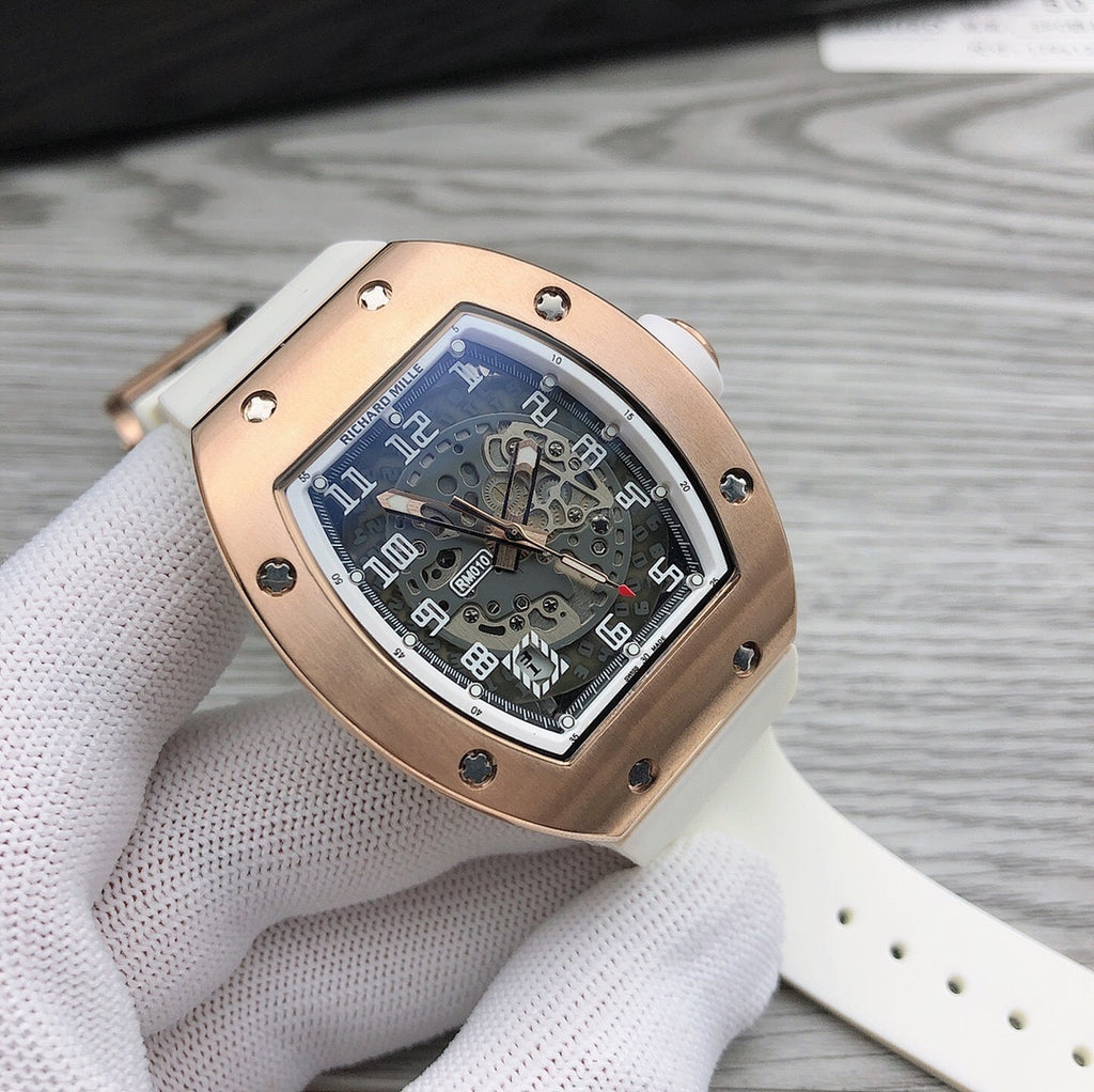 Richard Mille watch with rose-gold case, skeleton dial, and light perforated strap.