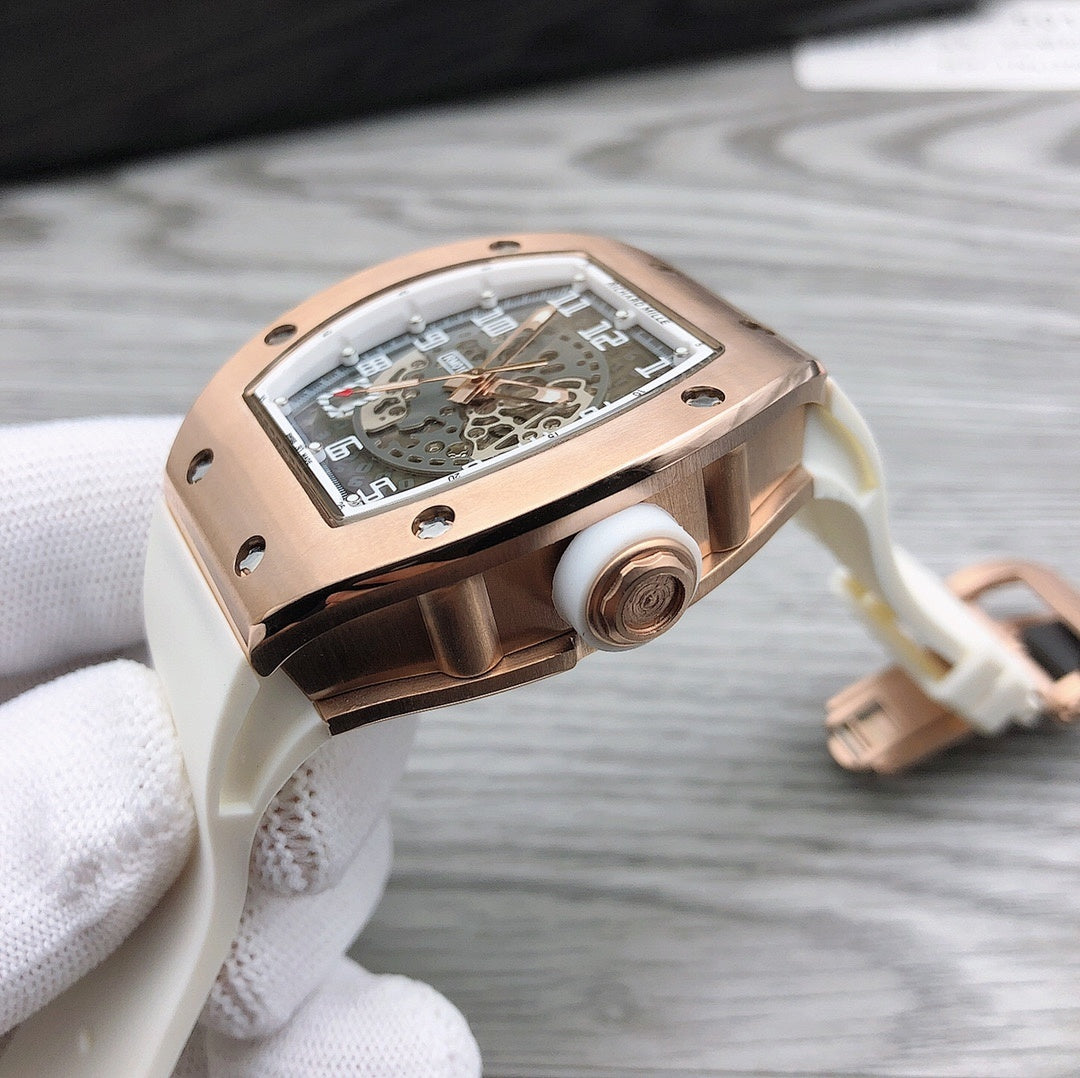 Richard Mille watch on white strap, rose-gold case side view with crown.