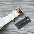 White rubber watch strap with rose-gold buckle and Richard Mille hang tag.