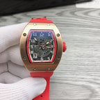Richard Mille watch with rose-gold case, black skeleton dial, and red strap.