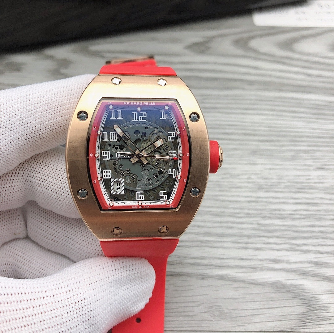Richard Mille watch with rose-gold case, black skeleton dial, and red strap.