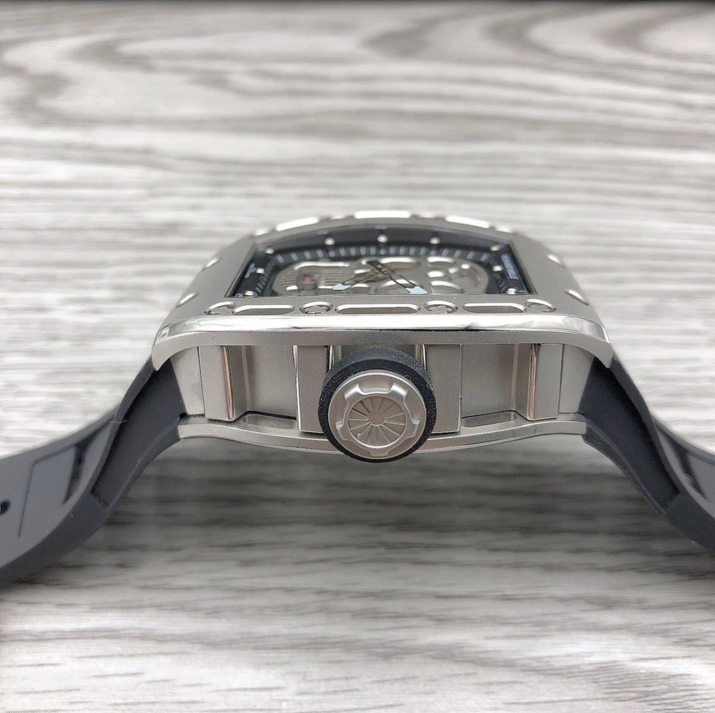 Top view of skeleton sport watch with silver case bezel and black rubber strap