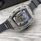 Silver-toned sport watch with black strap and clear dial showing visible mechanics