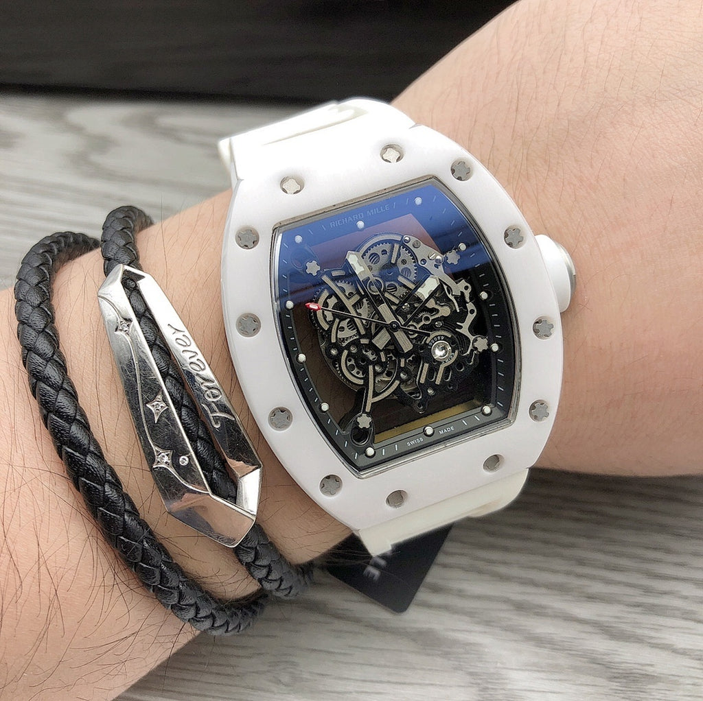 Richard Mille watch on wrist, white square case with blue-black skeleton dial