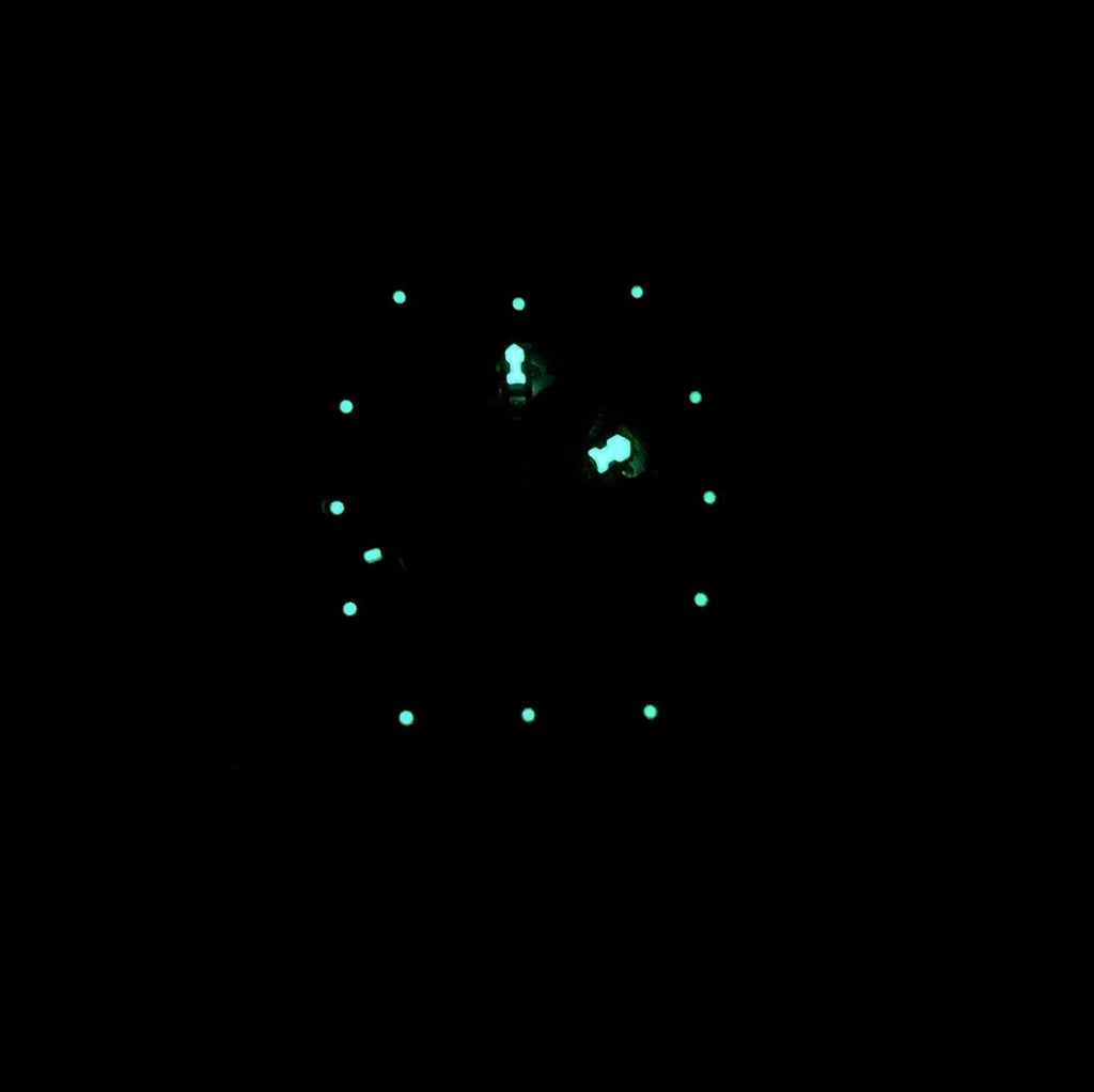 Richard Mille watch dial with glowing markers on dark face