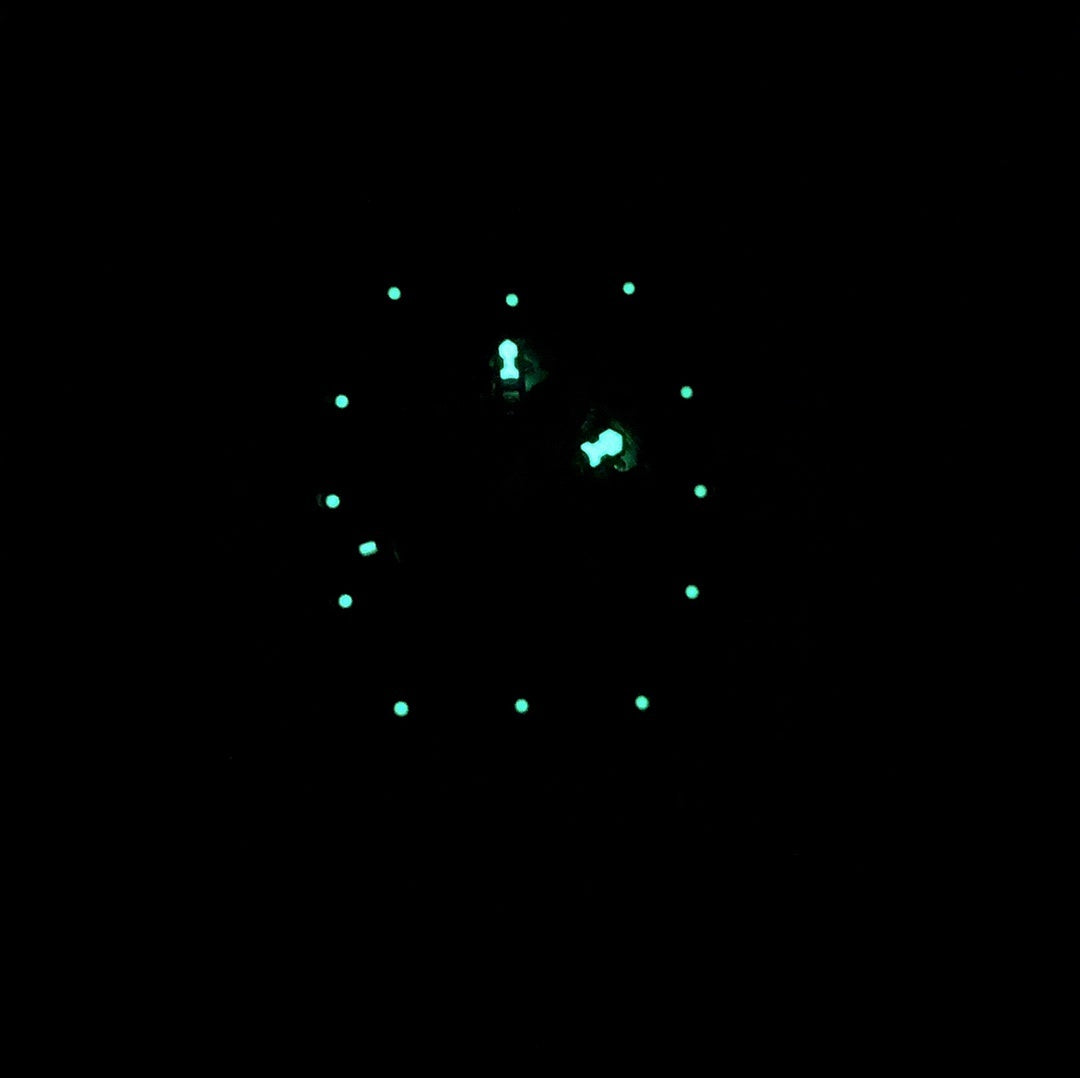 Richard Mille watch dial with glowing markers on dark face
