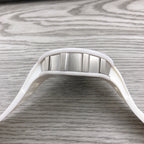 Richard Mille watch top view, stainless bezel and white strap