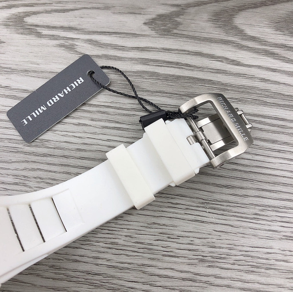 Richard Mille watch clasp on white strap with metal buckle and hang tag