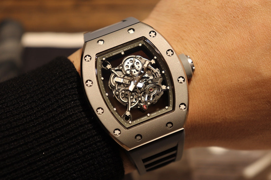 Richard Mille wristwatch with skeleton dial and black rubber strap on wrist