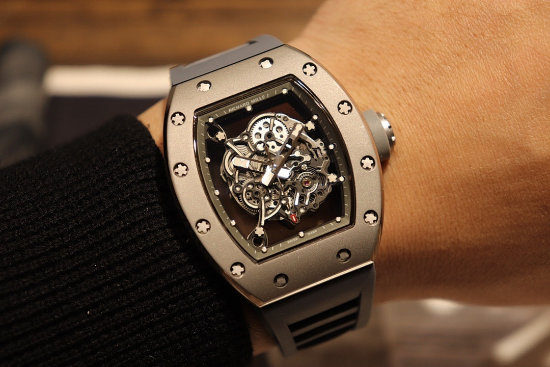 Richard Mille wristwatch with skeleton dial and black rubber strap on wrist