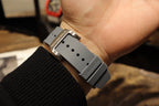 Richard Mille wristwatch with perforated gray strap on wrist
