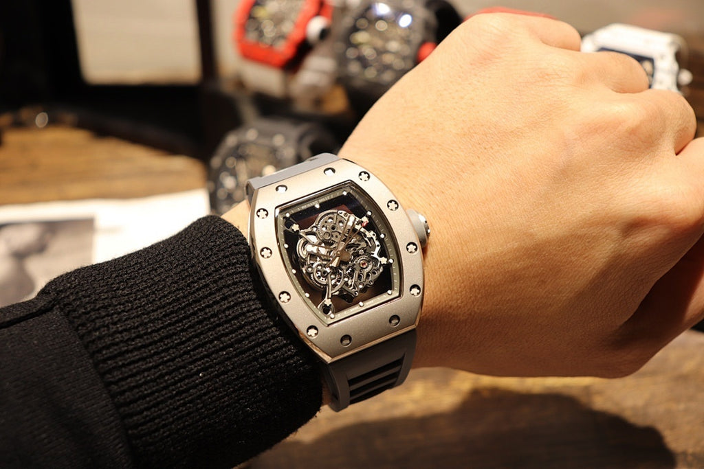Richard Mille wristwatch with skeleton dial and black rubber strap on wrist