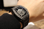 Black skeleton wristwatch with textured dial frame and rubber strap
