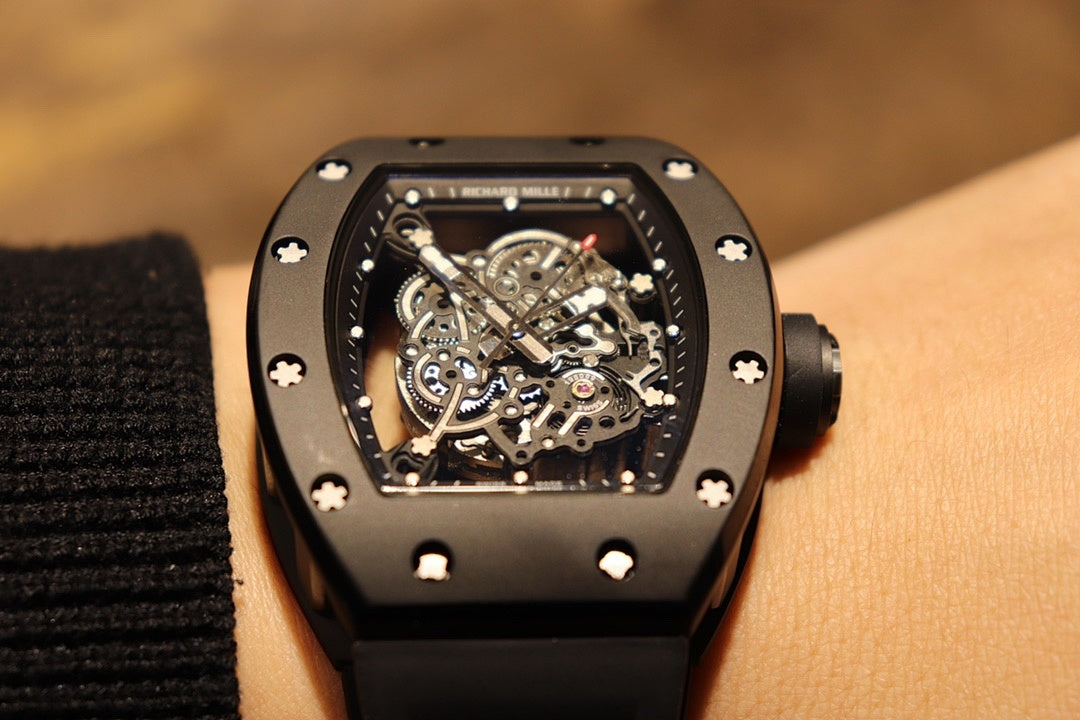 Black skeleton wristwatch, close-up of exposed gears in square dial